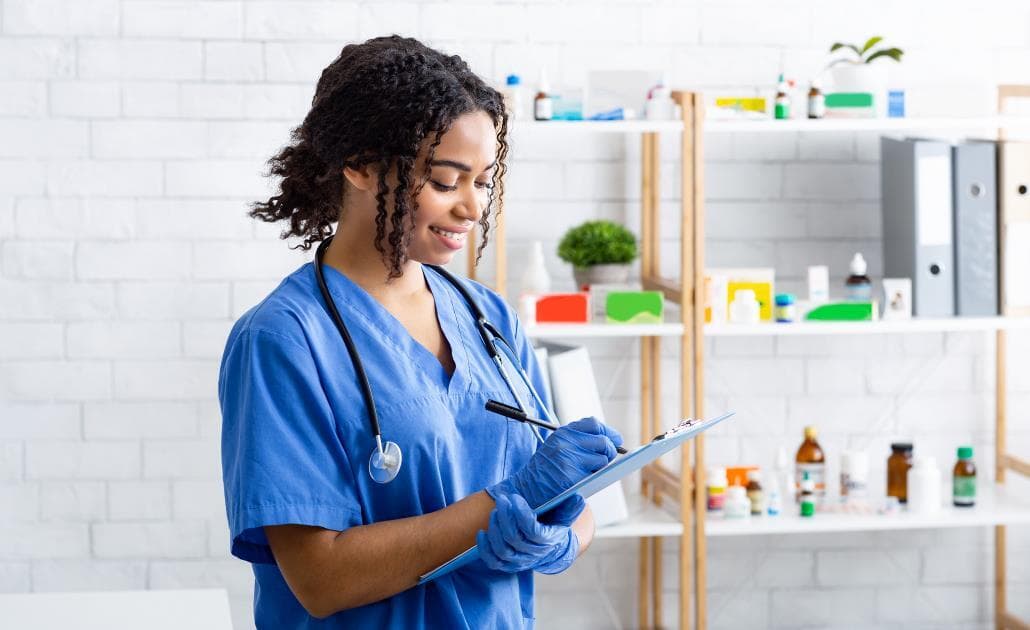 Young vet writing on clipboard 1030 x 630