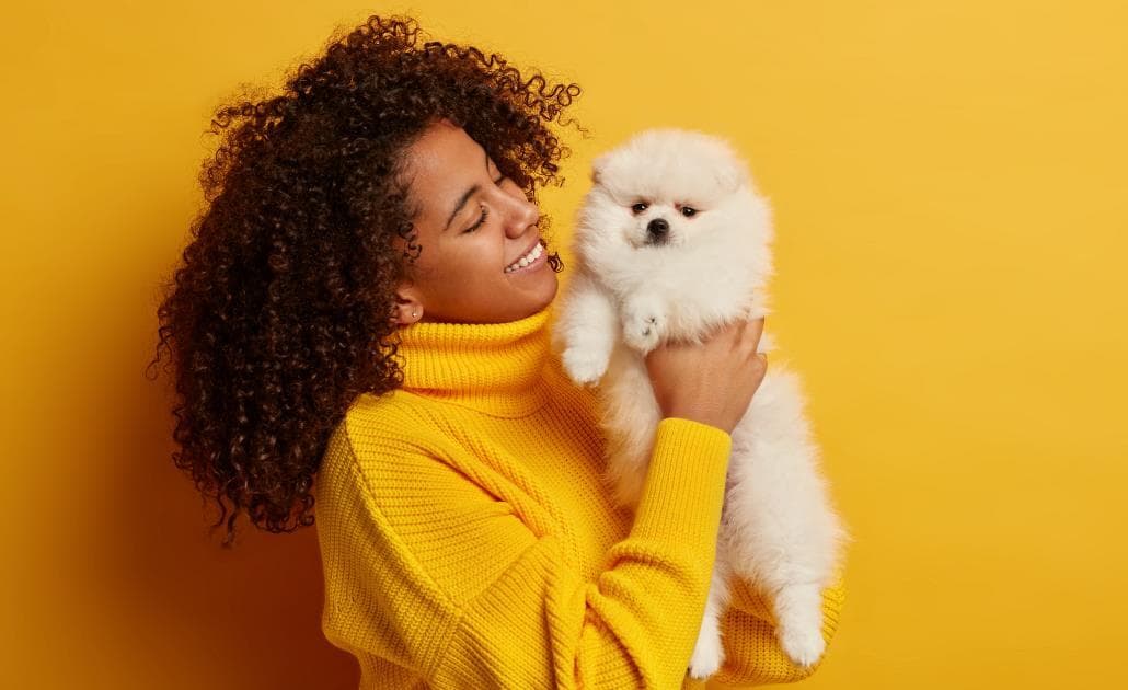 Woman holding dog 1030 x 630
